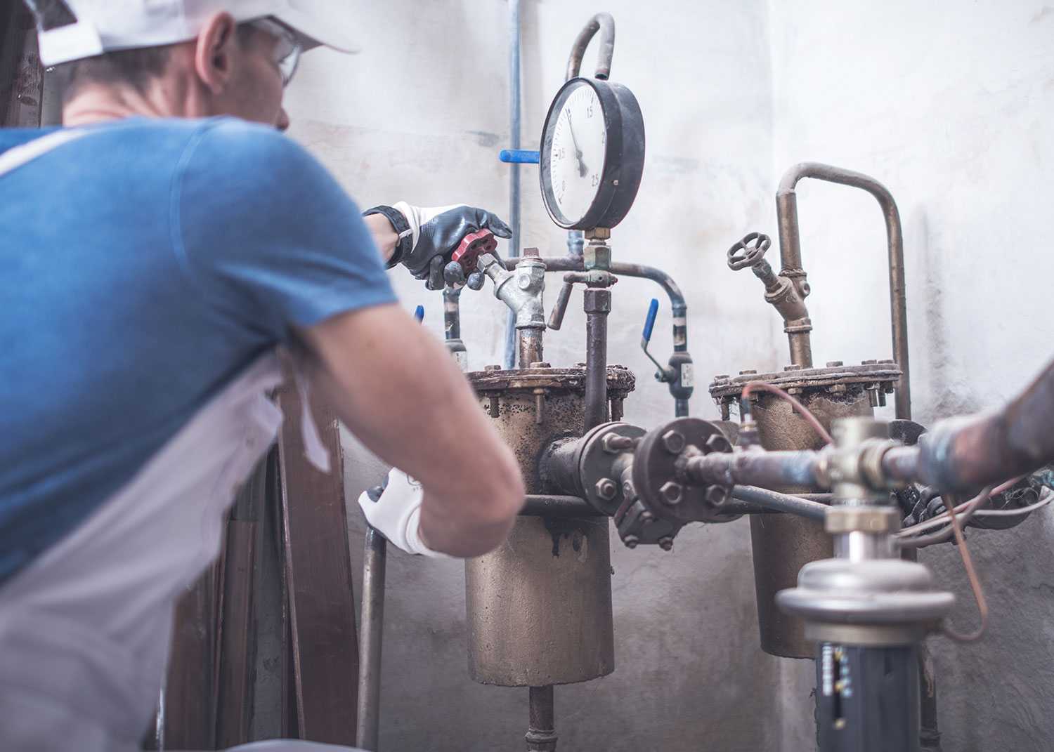 plumbing worker repairing a water pipe
